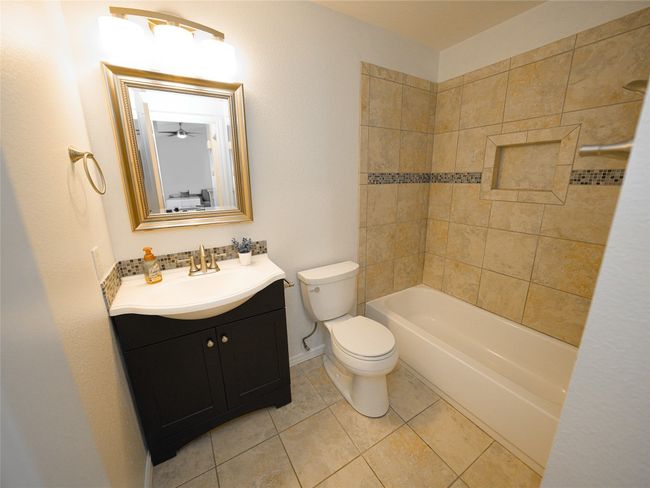 Full bath with tile patterned floors, baseboards, vanity, and toilet | Image 19