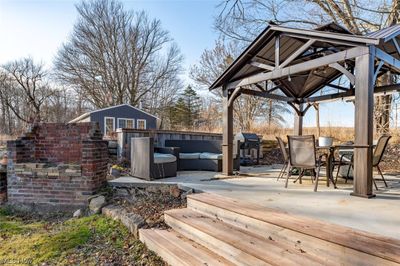 Deck with a gazebo, outdoor lounge area, and a patio | Image 2