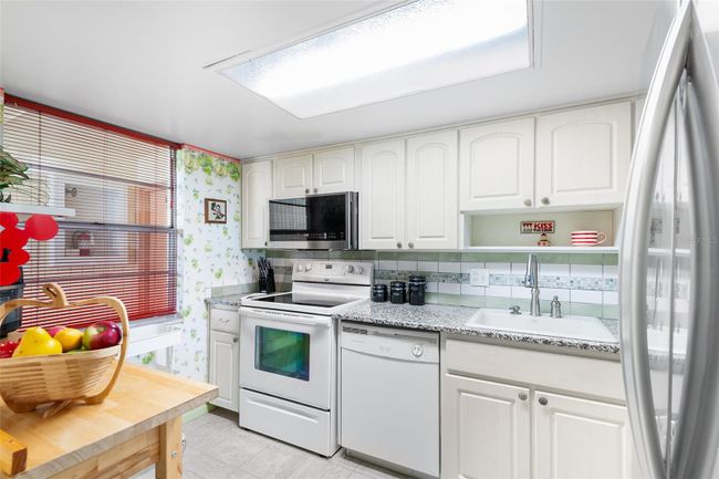 KITCHEN. NOTE ATTRACTIVE CABINETRY, COUNTERTOP AND BACKSPLASH! | Image 15
