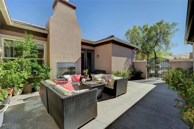 View of gated courtyard with fireplace | Image 10