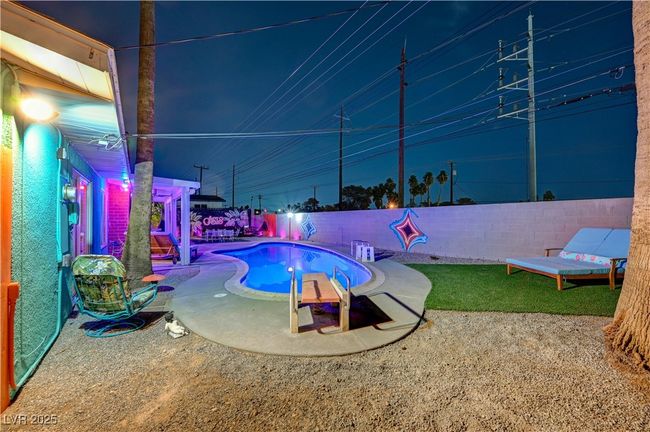 View of swimming pool with a fenced backyard and a fenced in pool | Image 41