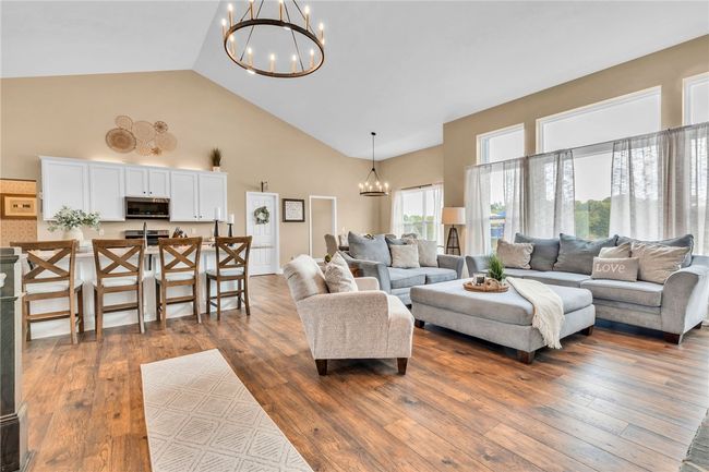 Soaring ceilings and a wall of windows are highlighted in the main living space. | Image 13