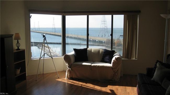 Living room with window view of the James River.Entertainment center & large sofa convey. | Image 6