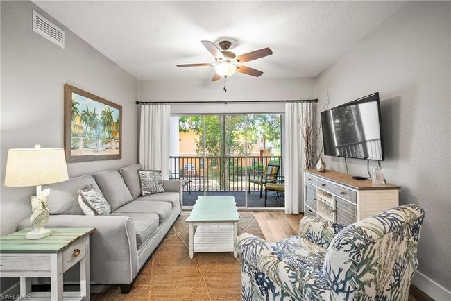 Living area with a ceiling fan, baseboards, and visible vents | Image 21