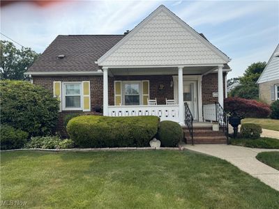 View of front facade featuring a front lawn and covered porch | Image 1