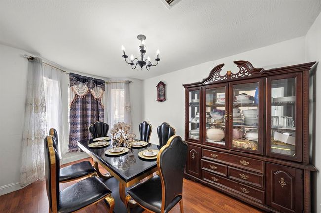 Located just off the main entry, this spacious dining room offers direct access to the kitchen and living spaces—ideal for entertaining and easy day-to-day flow. | Image 12