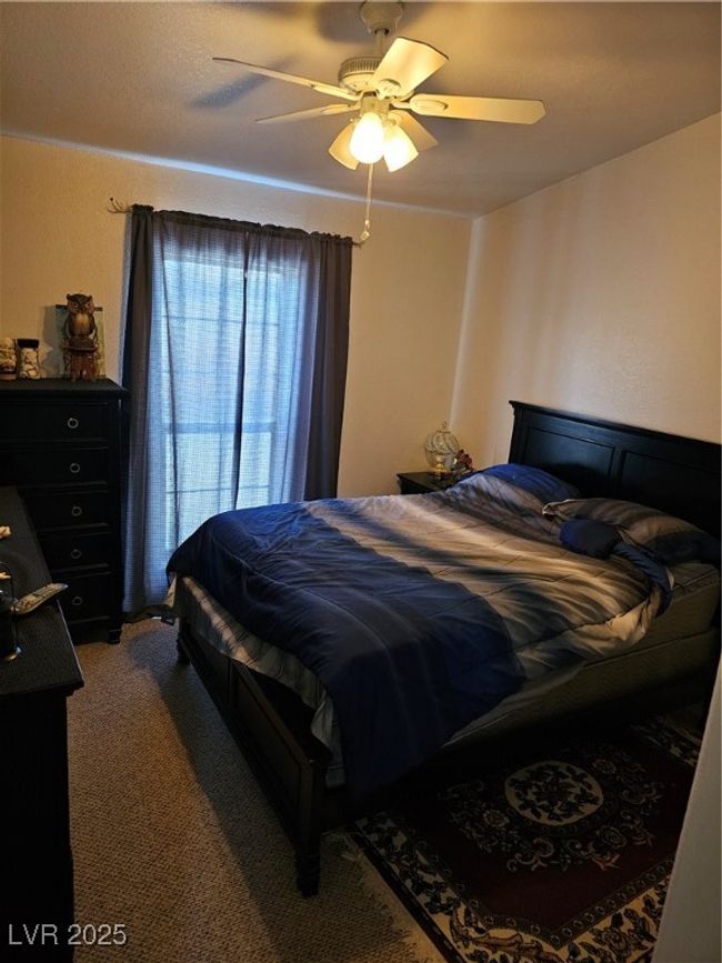 Carpeted bedroom featuring a ceiling fan | Image 14