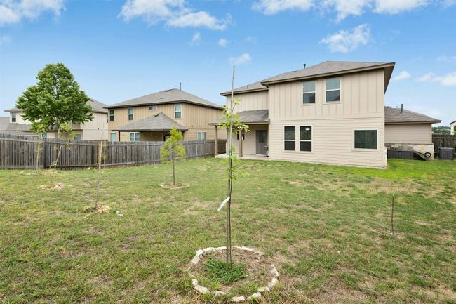Out back, the covered patio and wide-open yard give you a blank canvas to personalize. | Image 18