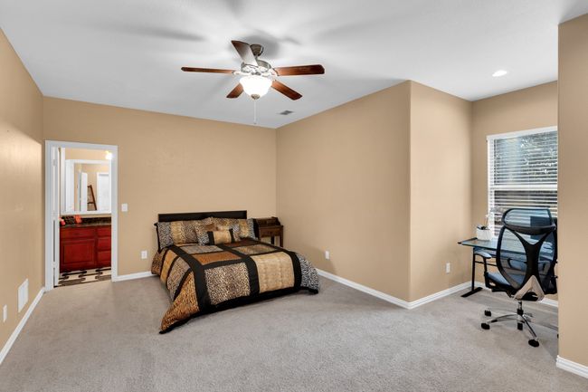 Upstairs bedroom with full bath, ceiling fan, recessed lighting & window niche | Image 31