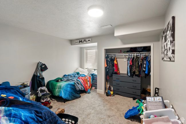 Bedroom featuring carpet floors, a closet, and a textured ceiling | Image 23
