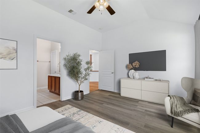 Bedroom with wood finished floors, vaulted ceiling, a ceiling fan, and ensuite bathroom | Image 16