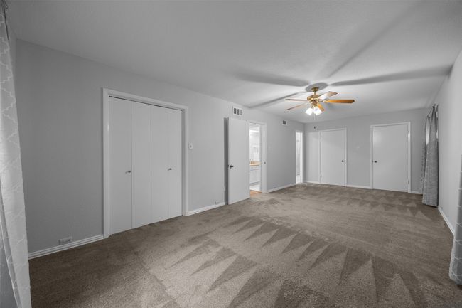 Unfurnished bedroom featuring carpet, ceiling fan, baseboards, and ensuite bathroom | Image 16