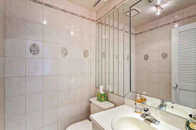 Bathroom featuring vanity and tile walls | Image 14