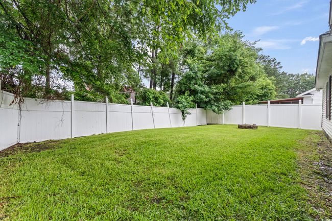 View of fenced backyard | Image 26