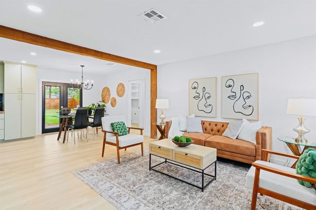 Living room with a chandelier, light wood-type flooring, recessed lighting, and beamed ceiling | Image 7