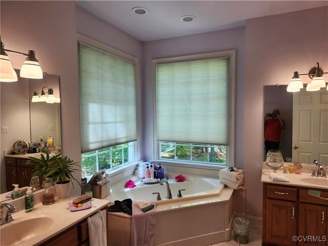 Bathroom with two vanities, a garden tub, and a sink | Image 28