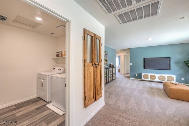 Photo is representational only; actual home finishes may vary. Laundry area featuring attic access, baseboards, washer and dryer, and carpet floors | Image 38