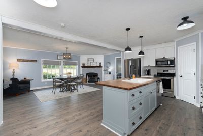 Newly renovated kitchen features a kitchen island with butcher block counter and farmhouse sink, stainless steel appliances and slow close wood cabinets! | Image 3