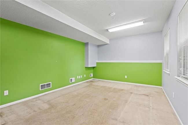 Empty room with carpet and a textured ceiling | Image 31