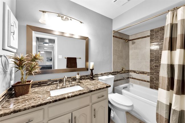 Full bath with vanity, shower / bathtub combination with curtain, and tile patterned flooring | Image 21