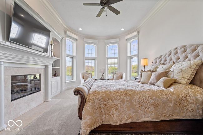 Primary bedroom is located on the main level and features a gas fireplace, and the most magnificent view of your backyard oasis. | Image 31