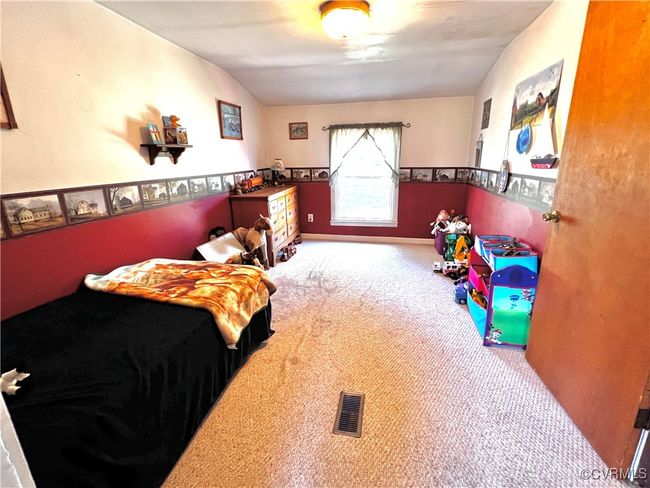 Carpeted bedroom with vaulted ceiling | Image 27