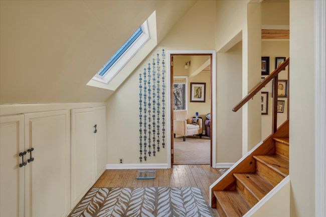 Additional living space with lofted ceiling with skylight and light wood-type flooring | Image 13
