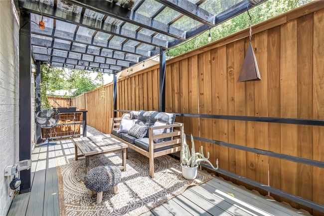 Wooden terrace with a pergola and outdoor lounge area | Image 37