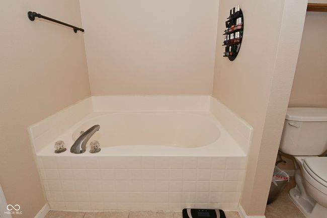 bathroom with toilet and a bath | Image 43