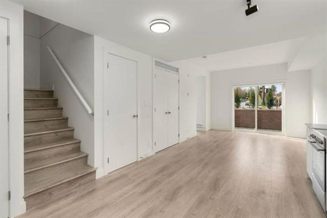 Unfurnished living room with light wood finished floors and stairs | Image 9