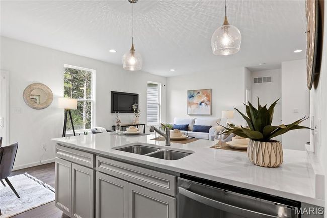 Kitchen featuring a sink, stainless steel dishwasher, open floor plan, light countertops, and recessed lighting | Image 18