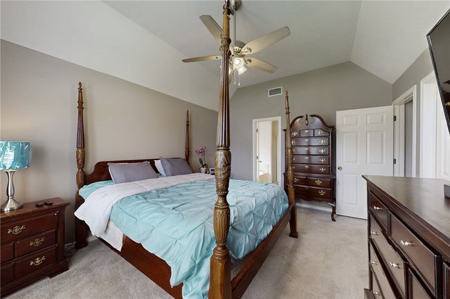 Bedroom featuring vaulted ceiling, light carpet, and ceiling fan | Image 21