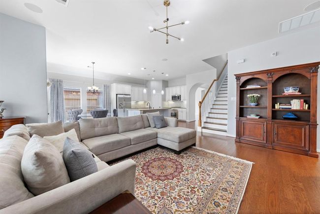 This open-concept layout blends kitchen, dining, and living areas for easy, connected living in a clean, neutral setting. | Image 13