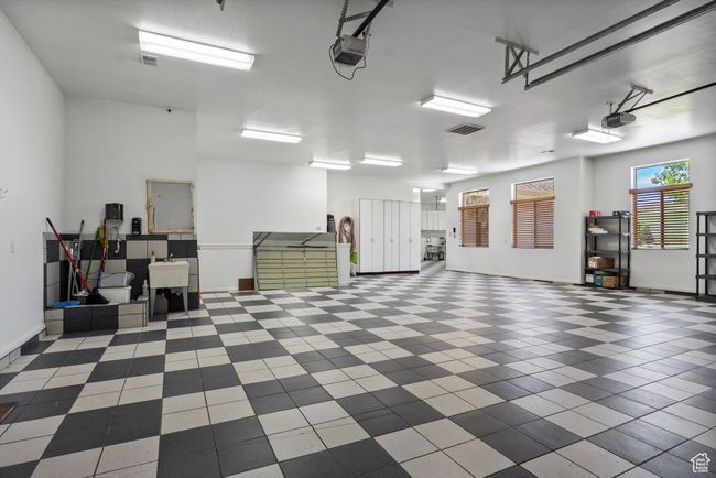 Garage with a garage door opener and baseboards | Image 68