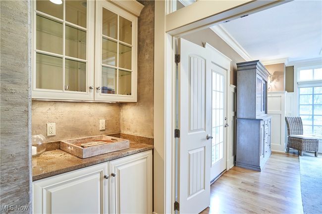 The home adds to detail with the serving cabinet between the dining room and kitchen | Image 10