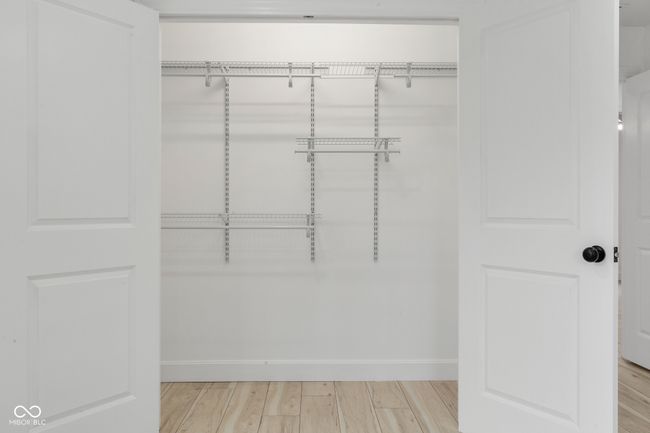 spacious closet featuring light wood-type flooring | Image 45