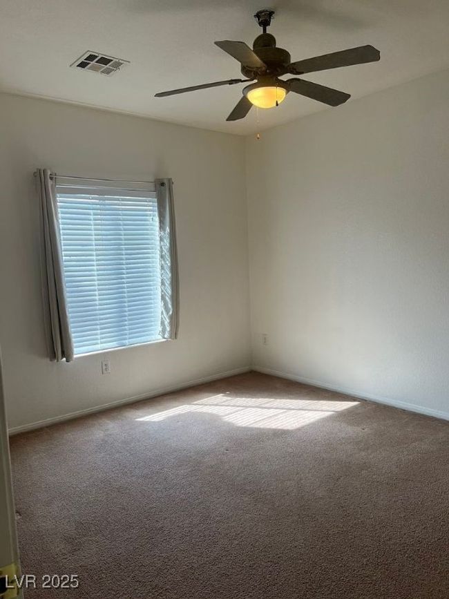Empty room with carpet floors and ceiling fan | Image 12