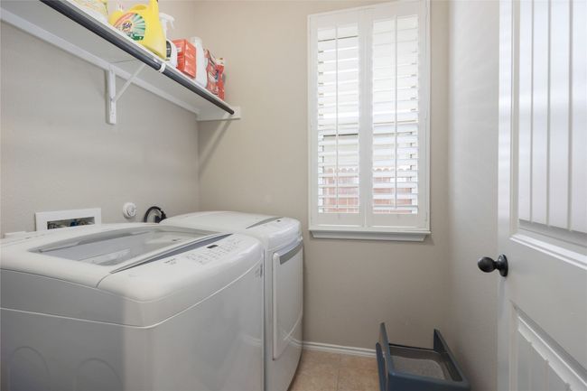 Washroom featuring separate washer and dryer, baseboards, and light tile patterned floors | Image 28
