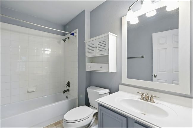 Full bathroom with vanity, toilet, and shower / tub combination | Image 21
