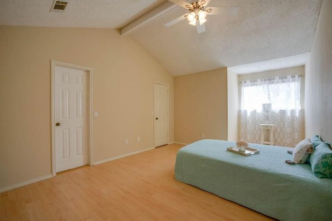 Bedroom with wood finished floors, a textured ceiling, baseboards, and ceiling fan | Image 18