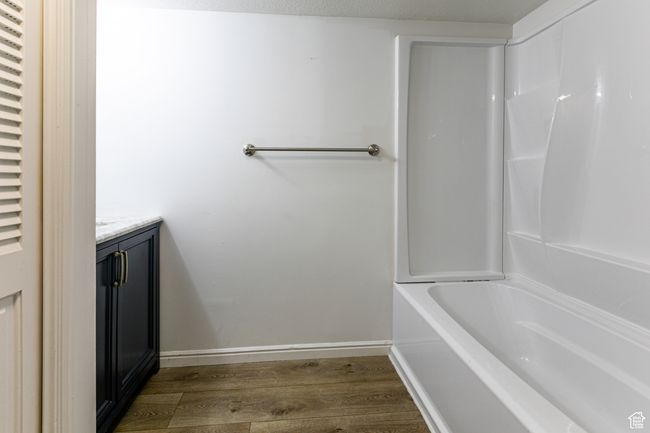 Bathroom with wood finished floors, vanity, and baseboards | Image 28