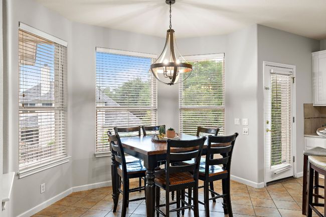 The breakfast nook features a bay window that looks out over the beautiful backyard! | Image 21