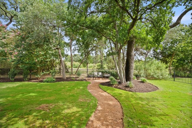 A gravel path leads you to a peaceful sitting area where you can sit back and enjoy the soothing sounds of nature along the greenbelt | Image 37