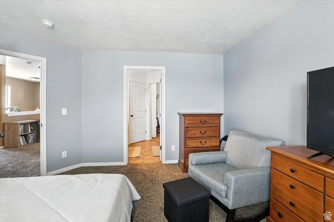 Carpeted bedroom featuring baseboards and a textured ceiling | Image 19