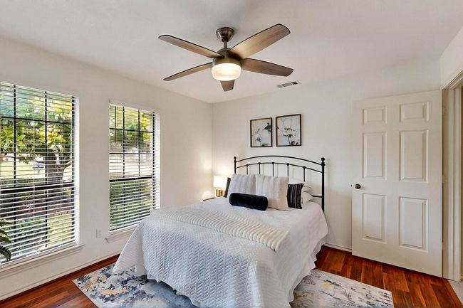 Bedroom featuring wood finished floors and a ceiling fan | Image 29