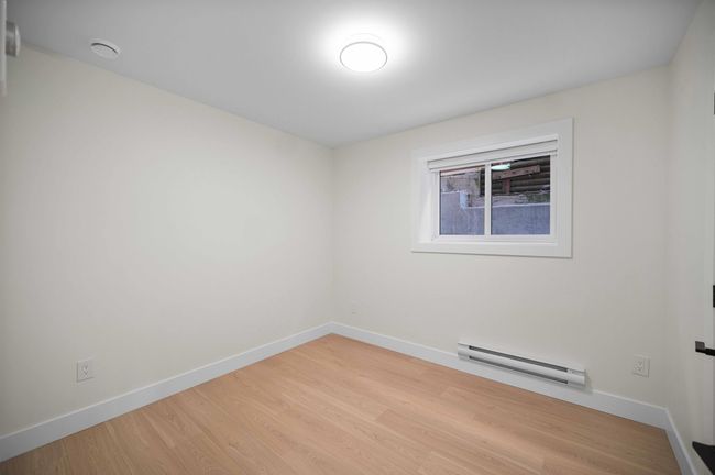 Unfurnished room featuring baseboard heating and wood finished floors | Image 21