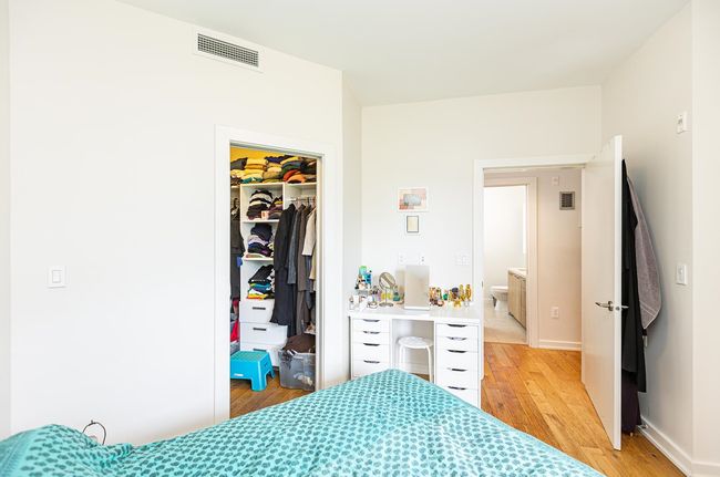 Bedroom featuring light wood-style flooring, a walk in closet, a closet, and baseboards | Image 8