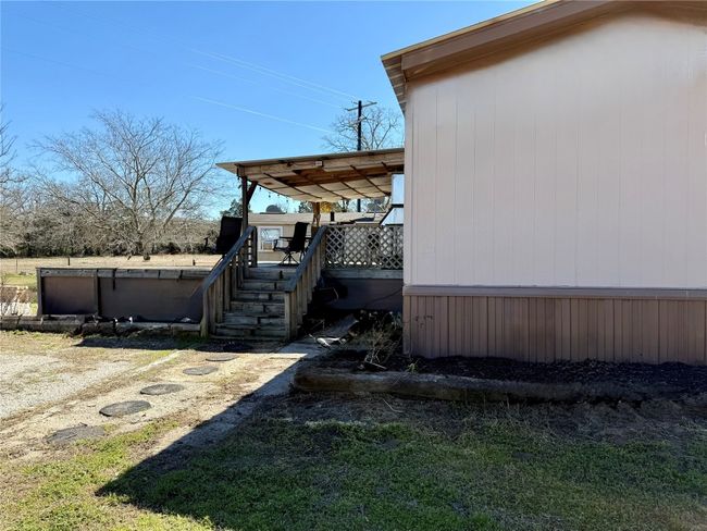 View of property exterior featuring stairway and a wooden deck | Image 5