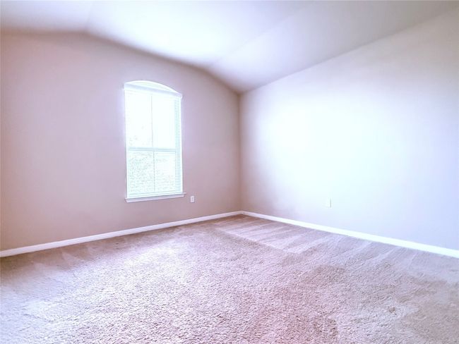 Empty room featuring carpet and vaulted ceiling | Image 14