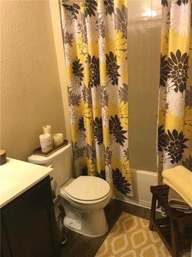 Full bath featuring vanity, toilet, wood finished floors, and shower / bath combo | Image 11